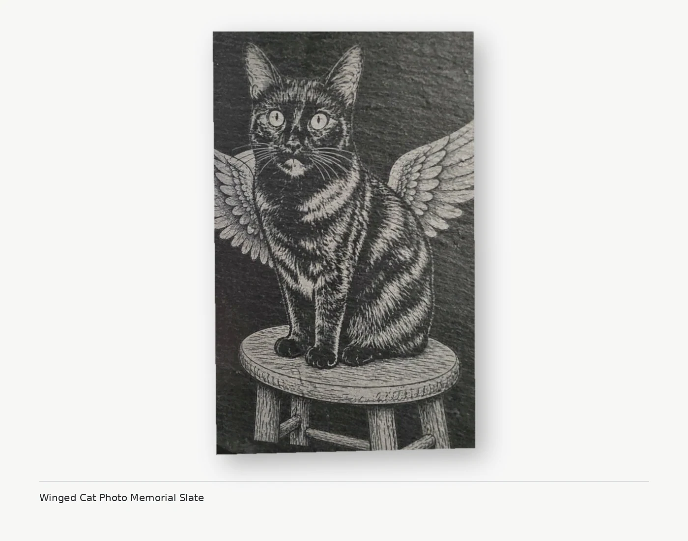 Memorial engraving of a cat with angel wings on natural slate